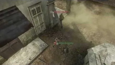 Looking down on a player running past a shuttered window through dust, a teammate tagged below in the alley.
