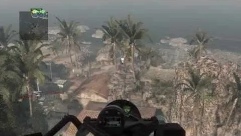 The chopper gunner's view over palm trees and a beach, crosshair on a marked target on the ground below.